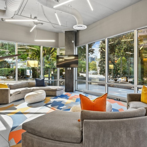 Resident clubhouse with plush couches and a tv